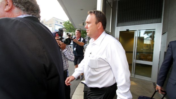 Gold Coast private investigator Mick Featherstone exits the Brisbane Watchhouse after being released on bail on Friday afternoon. 