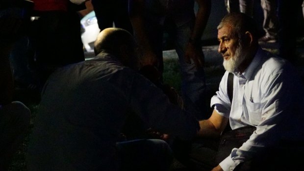 A passenger's blood pressure is checked by health officials outside  Istanbul Ataturk after the attack.