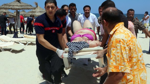 Tunisian medics carry a woman on a stretcher in the resort town of Sousse.