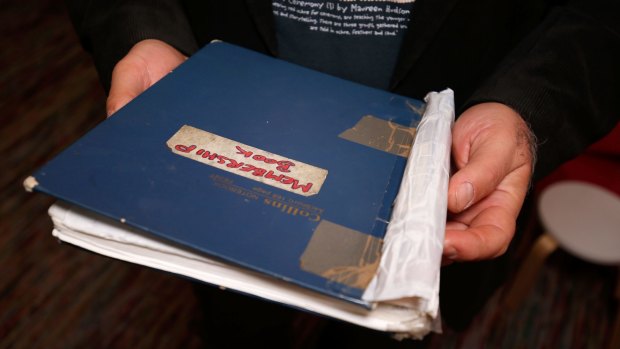 The blue book containing the names of thousands of people the Asylum Seeker Resource Centre has assisted since 2001.