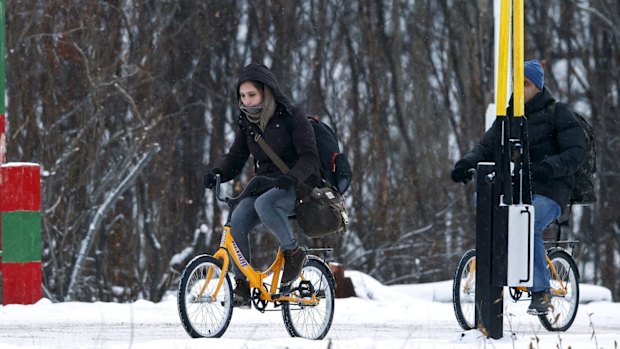 Two refugees use bikes to cross the border between Norway and Russia in Storskog near Kirkenes in Northern Norway, in November 2015. 