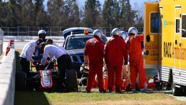Worrying scene: Fernando Alonso receives medical assistance after crashing  at Circuit de Catalunya.