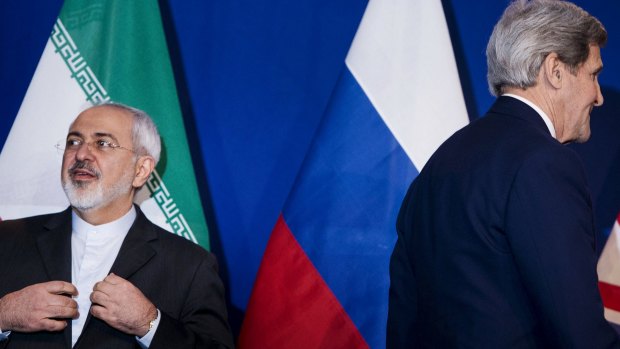 Iranian Foreign Minister Javad Zarif (left) waits to make a statement next to US Secretary of State John Kerry (right), following nuclear talks in Lausanne.