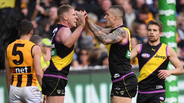 Up and at 'em: Josh Caddy and Dustin Martin celebrate another six points for the Tigers.