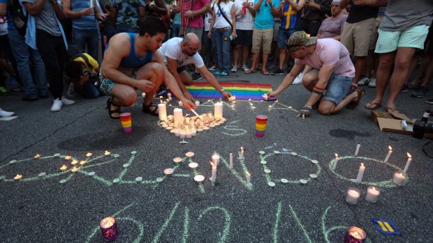 People light candles as members and supporters of the LGBT community gather for a vigil in Atlanta following the shooting in Orlando.