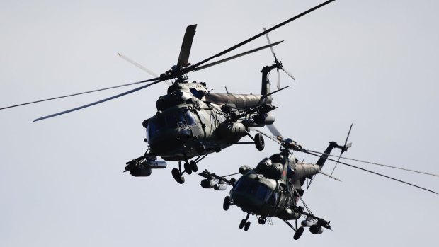 Two Belarusian military helicopters fly during military exercises near the Volka village, 200 kilometres south-west of Minsk, Belarus.