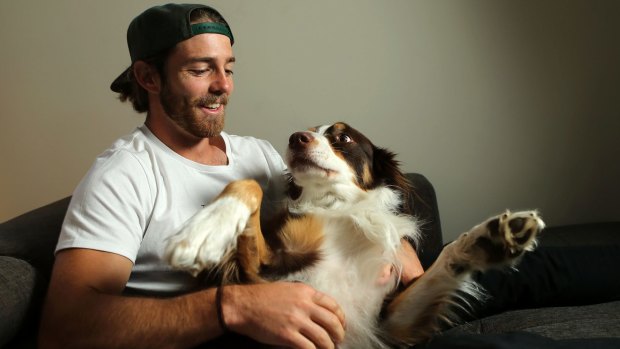 Travis Colyer at home with his dog Toby. 