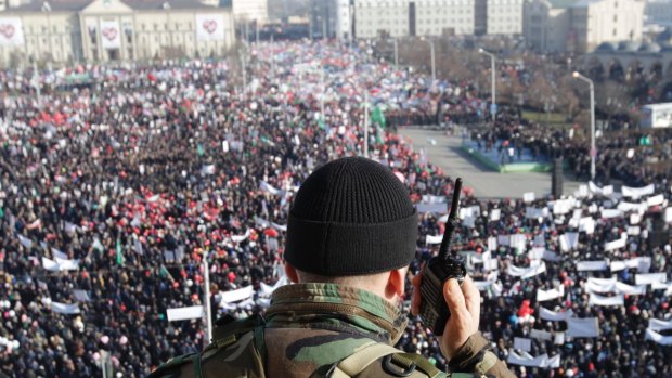 On watch: A law enforcement officer stands guard during the rally in Grozny, Chechnya.