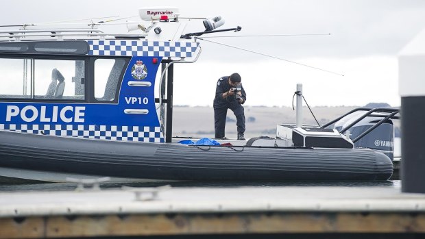 Police at the scene of the crash of a plane which killed four people.