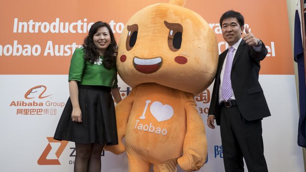 Bold move: Alipay International president Sabrina Peng  and Taobao's Tang Yongbo pose with the Taobao mascot at the launch. 