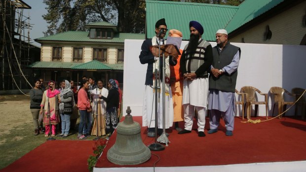 The old bell that was removed takes centre stage as people from various faiths including Muslims, Hindus and Sikhs participate in the installation of the new bell at the Holy Family Catholic Church in Srinagar.