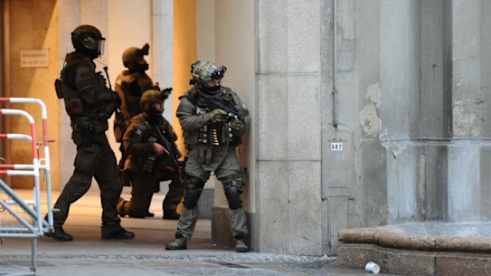Heavily armed police forces operate at Karlsplatz (Stachus) square after a shooting in the Olympia shopping centre was reported in Munich, southern Germany, Friday, July 22, 2016. (Andreas Gebert/dpa via AP)