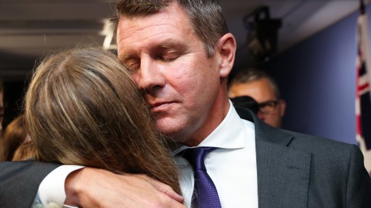Premier Mike Baird hugs his daughter after a press conference announcing his resignation in Sydney. 