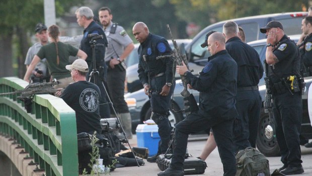 Police gather to set up to contain a reported lion in Milwaukee, Wisconsin, on Monday.