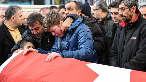 Relatives and friends mourn Ayhan Arik, one of the 39 victims of the nightclub attack.