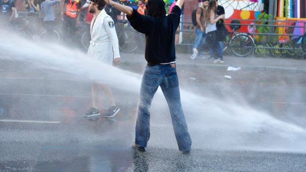 Protesters run the gauntlet of the water cannons. 