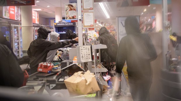 Anarchists ransack a supermarket as part of G20 protests. 