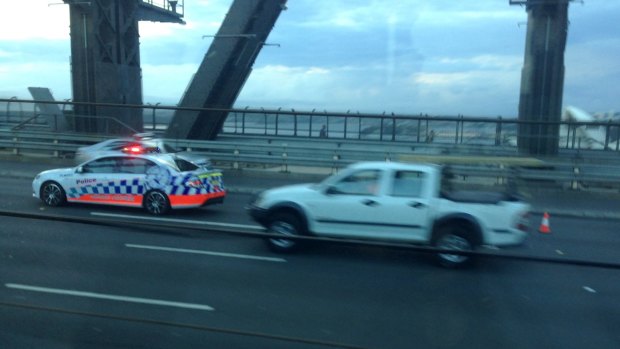 Police and emergency services vehicles on the Sydney Harbour Bridge following the crash this morning.