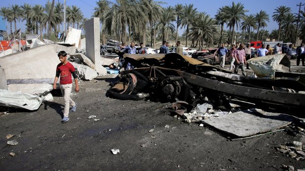 A suicide bomber rammed his explosives-laden fuel truck into a security checkpoint south of Baghdad, killing and wounding dozens.