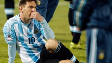 Losing feeling: Lionel Messi watches  Chile raise the Copa America trophy.