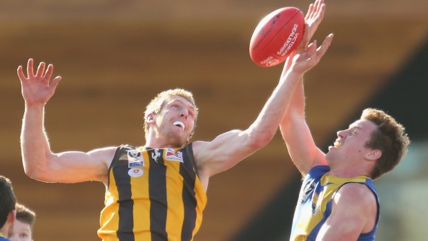 Ben McEvoy of the Hawks and Nick Meese of  Williamstown compete for the ball during the VFL preliminary final at North Port Oval on Sunday.