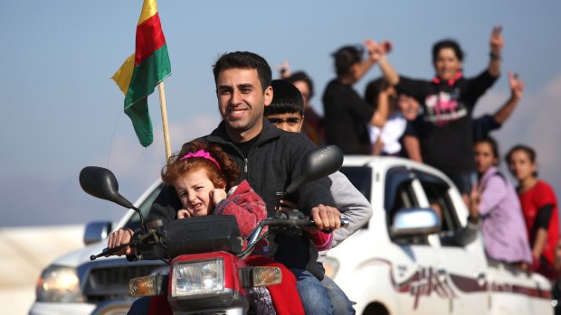 Yazidi refugees celebrate news of the liberation of their homeland of Sinjar from IS extremists, while at a refugee camp in Derek, Rojava, Syria. 