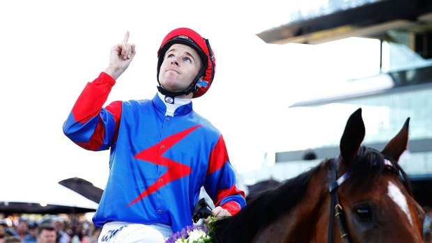 Jockey Tommy Berry, with what has become a customary salute to his twin brother, Nathan. 