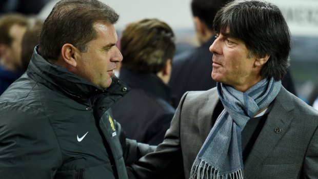 Listening: Ange Postecoglou is greeted by World Cup-winning coach Joachim Loew of Germany.