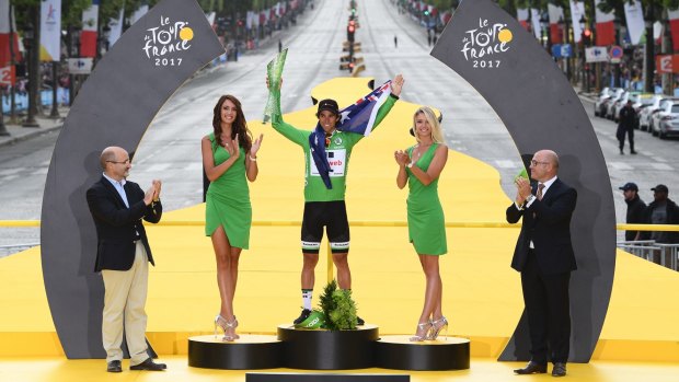 Australian rider Michael Matthews is flanked by so-called 'podium girls' after winning the green jersey for Team Sunweb at last year's Tour de France.