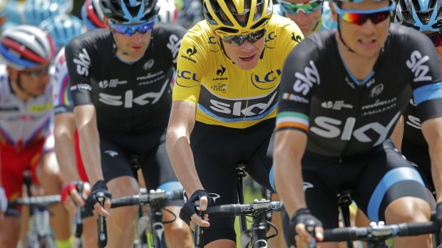 Britain's Christopher Froome, wearing the overall leader's yellow jersey, rides in the pack during the eighth stage of the Tour de France.
