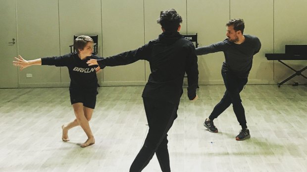 Rohan Browne and choreographer Michael Ralph work with one of the young dancers in <i>Self</i>.