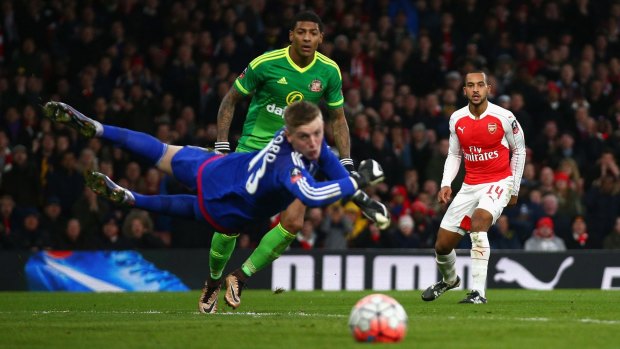 Gunner score: Arsenal's Theo Walcott looks on as he fires a shot past Sunderland keeper Jordan Pickford.