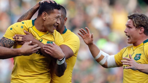 Mobbed: Israel Folau is congratulated by Kurtley Beale and Michael Hooper after scoring against South Africa.