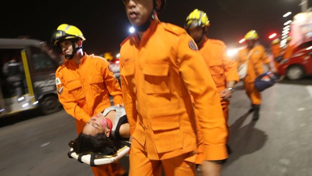An anti-impeachment demonstrator is carried on a stretcher by rescue workers after being overcome by police pepper spray at a demonstration in Brasilia on Wednesday.
