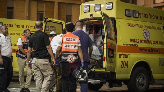 An injured Israeli soldier is seen as an ambulance arrives at Hadas hospital in Jerusalem on October 17.