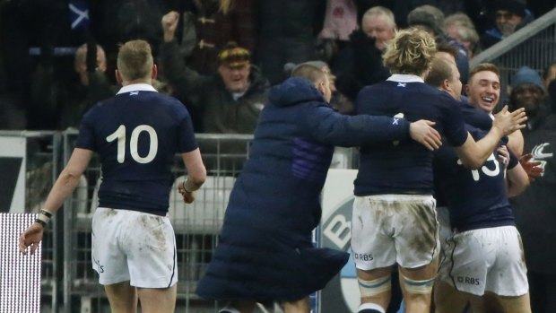 Scotland's Dougie Fife, right, smiles as he celebrates the first try with his teammates during their Six-Nations rugby union international match between France and Scotland at the Stade de France stadium in Saint Denis, outside Paris, Saturday Feb. 7, 2015. (AP Photo/Michel Euler)