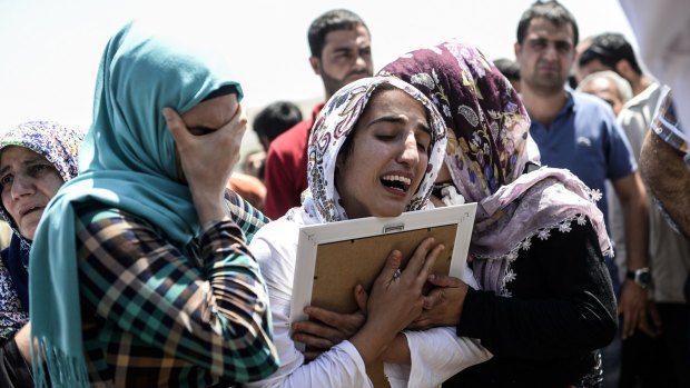 Relatives of 17-year-old victim Ramazan Yildiz mourn at his funeral.