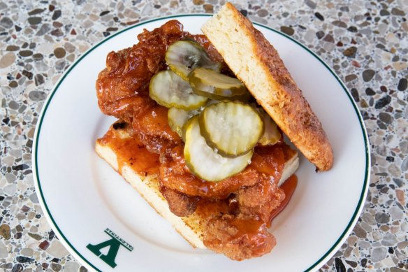 Fried chicken sandwich with deep-fried meat, hot honey butter and crinkle-cut pickles.