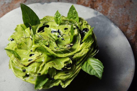 A rosette of iceberg lettuce, coconut, lime and charcoal.