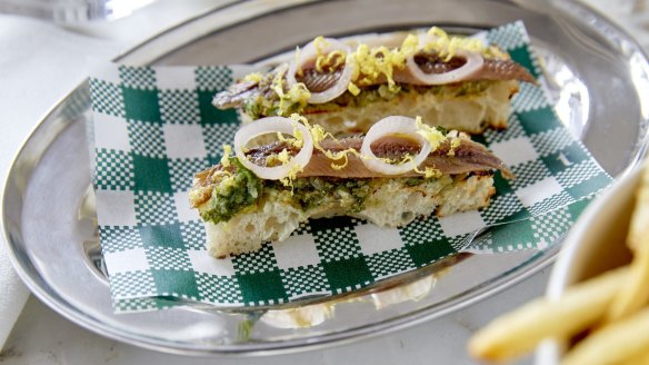 Anchovy toasts with salsa verde and lemon zest.