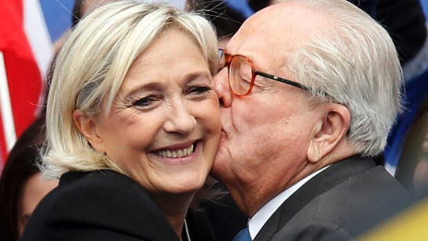 Happier times: Father and daughter embrace at a National Front rally in 2013. 