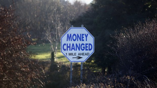 A sign advertising money exchange facilities stands on the roadside at the border between Northern Ireland and Ireland,.