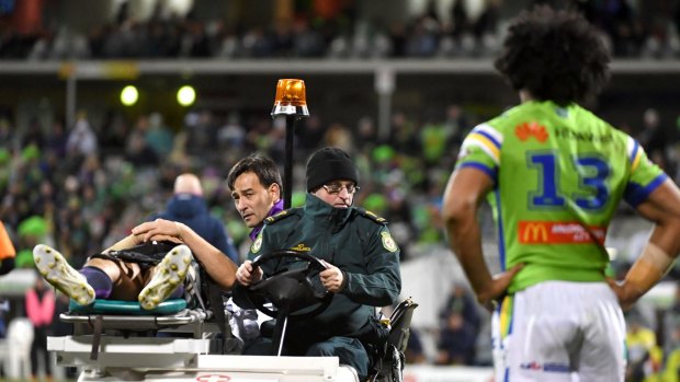 Hit man: Iosia Soliola looks on as Billy Slater is taken from the field.