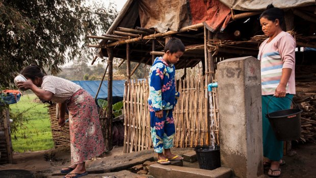 Aung Din, 12, displaced from Mung Ding Pa, collects water every morning for his household at the Phan Khar Kone camp in Bhamo city, Kachin State, Myanmar.