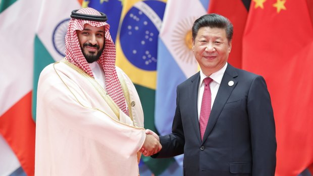 Among the powerful: Chinese President Xi Jinping (right) shakes hands with Saudi Arabian Deputy Crown Prince Mohammed bin Salman.