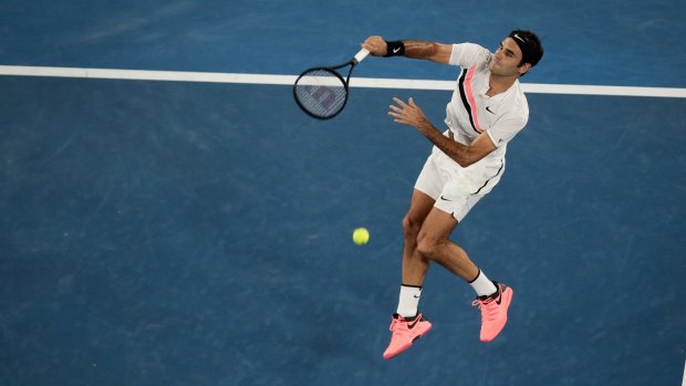 Dynamic: Roger Federer hits an overhead during his straight-sets victory on Rod Laver Arena.