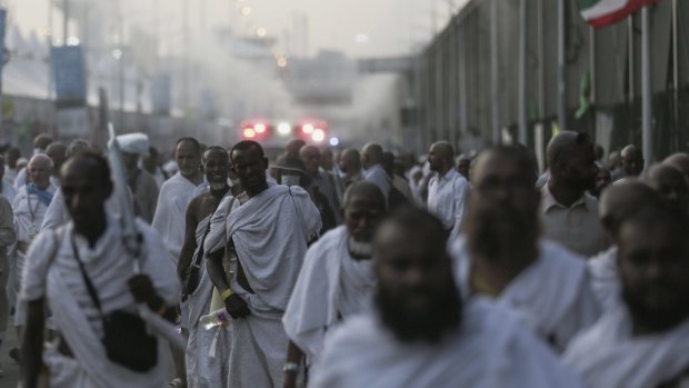 Pilgrims walk by the site where hundreds were crushed and trampled to death during the annual haj pilgrimage in Mina, Saudi Arabia.