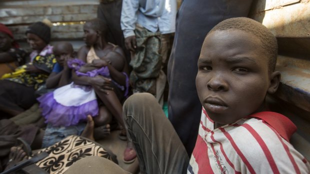 A South Sudanese boy gazes out from the back of a truck as he and others are transported to Nyumazi refugee centre in Uganda. 