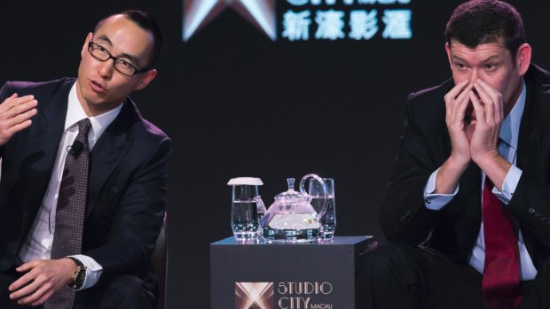 Melco Crown Entertainment co-chairman and chief executive officer Lawrence Ho, left, speaks as James Packer listens.
