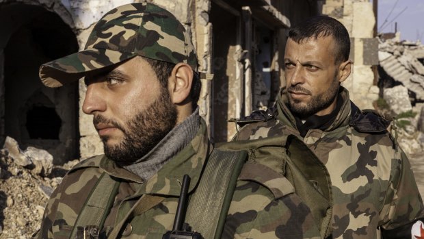 SSNP militiamen Yousef Khalaf (left) and Ibrahim al-Khalil patrol Homs.
